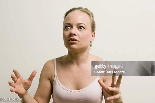 woman with shocked expression on face, hands raised, close-up - terrified woman stock pictures, royalty-free photos & images