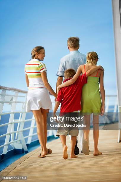 parents with children (10-12) walking on cruise ship, rear view - ladies shorts stock pictures, royalty-free photos & images