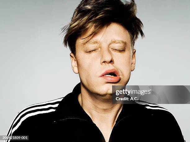 young man shaking head, eyes closed, close-up - shaking stock pictures, royalty-free photos & images