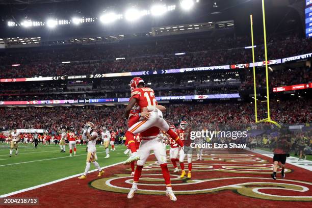 Mecole Hardman Jr. #12 of the Kansas City Chiefs celebrates with Patrick Mahomes and tafter scoring the game-winning touchdown in overtime to defeat...