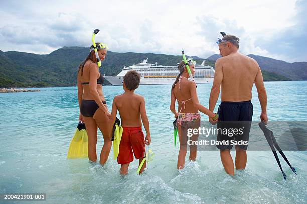 parents with children (10-12) in water with snorkel gear, rear view - cruise liner stock pictures, royalty-free photos & images