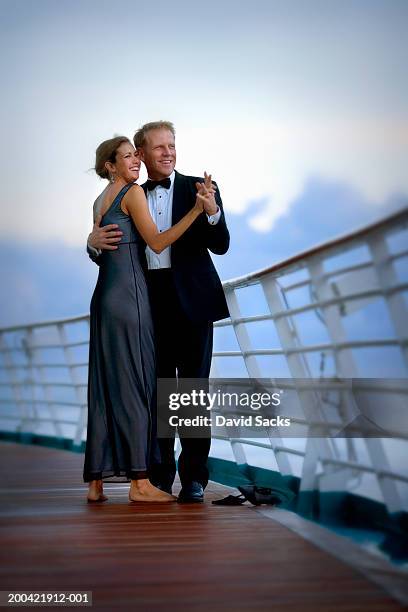 couple dancing on cruise ship, smiling - vestido-de-noche fotografías e imágenes de stock