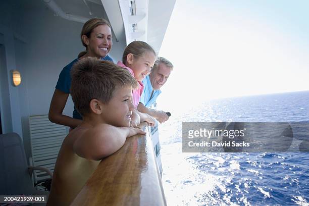 parents with children (10-12) on cruise ship looking at ocean - boat side view stock pictures, royalty-free photos & images