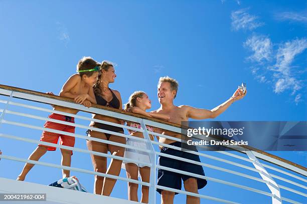 parents with children (10-12) talking near rail on cruise ship - kreuzfahrtschiff stock-fotos und bilder
