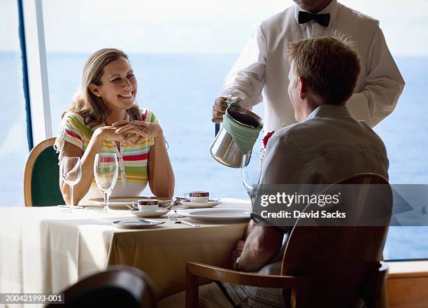 couple at table on cruise ship, smiling - dining chair stock pictures, royalty-free photos & images