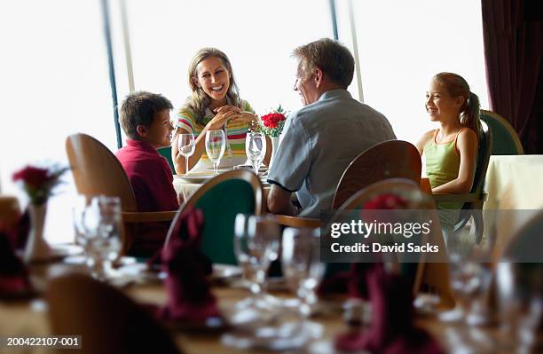 parents with children (10-12) at table on cruise ship - dining restaurant stock pictures, royalty-free photos & images