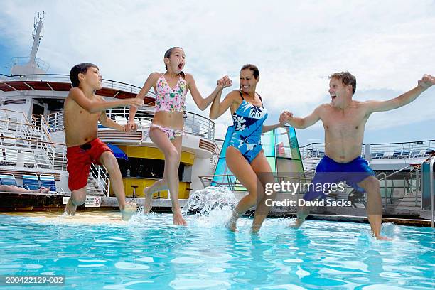 parents with children (10-12) jumping into pool on cruise ship - cruise ship ストックフォトと画像