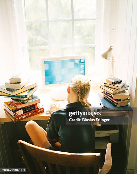 girl (11-13) studying at desk, rear view - estudiando flexo fotografías e imágenes de stock