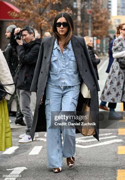 Guest is seen wearing a gray coat, denim top and pants with cream bag outside the Jason Wu show during NYFW F/W 2024 on February 11, 2024 in New York...
