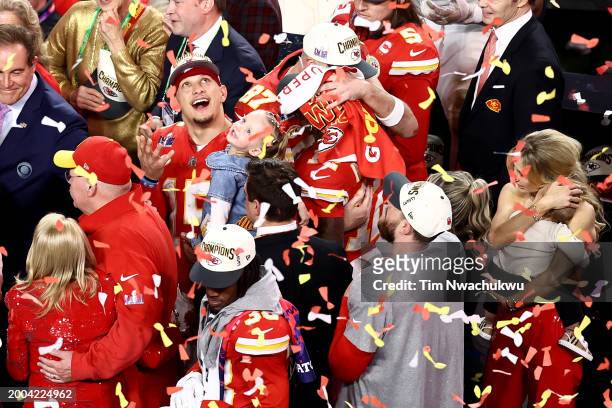 Patrick Mahomes of the Kansas City Chiefs holds his daughter while celebrating after defeating the San Francisco 49ers 25-22 during Super Bowl LVIII...