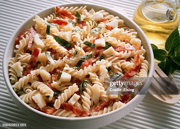 pasta salad with salami and basil - pasta salad stock pictures, royalty-free photos & images