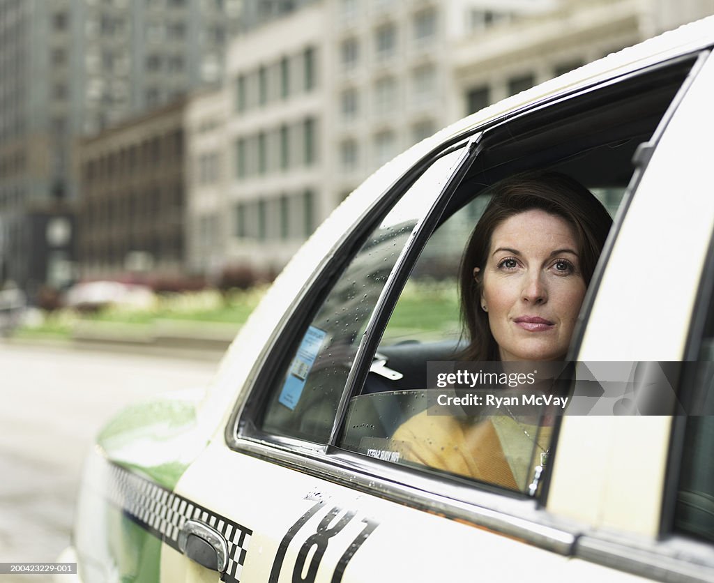 Mature businesswoman  sitting in taxi