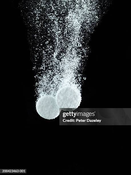 soluble pills in water, close up - effervescent tablet stock pictures, royalty-free photos & images