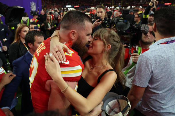 Travis Kelce of the Kansas City Chiefs and Taylor Swift embrace after defeating the San Francisco 49ers in overtime during Super Bowl LVIII at...