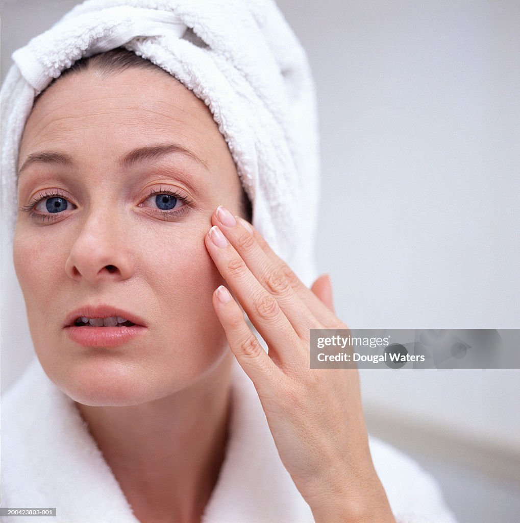 Woman touching face, portrait