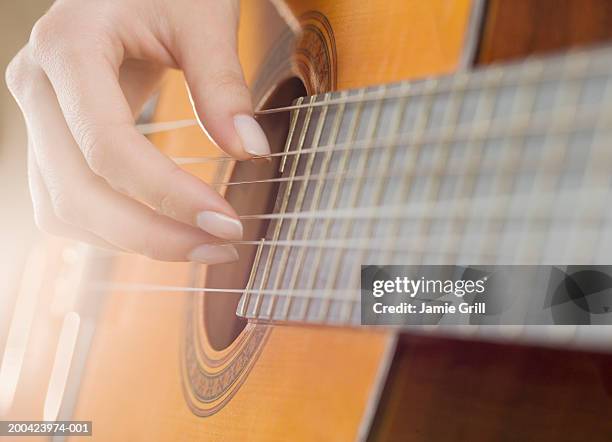 woman playing guitar, close-up (blurred motion) - acoustic guitar close up stock pictures, royalty-free photos & images