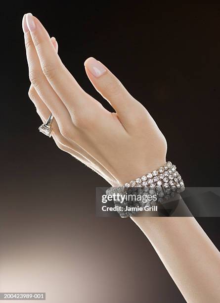 woman wearing diamond ring and bracelets, close-up - bracelet ストックフォトと画像