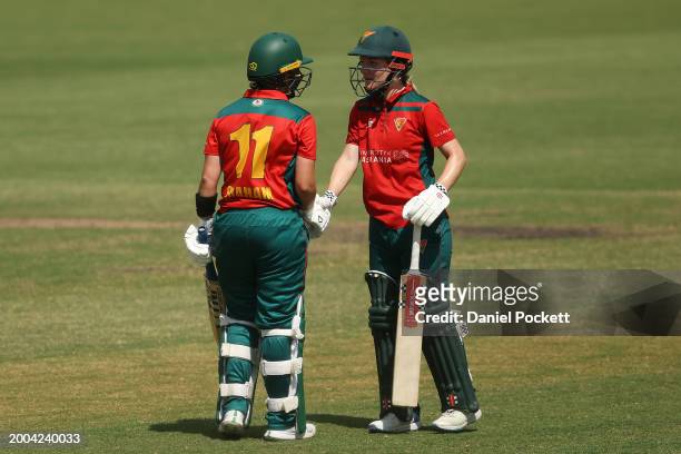 Heather Graham of Tasmania celebrates with Nicola Carey of Tasmania after making fifty runs during the WNCL match between Victoria and Tasmania at...