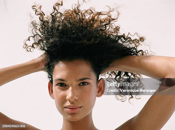 young woman lifting hair up, portrait, close up - beautiful latin women stock pictures, royalty-free photos & images