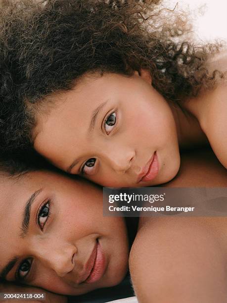 daughter (8-10) lying on mother, portrait, close up - frizzy hair stock pictures, royalty-free photos & images