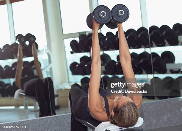 woman working out with weights in fitness room on cruise ship - weight bench stock pictures, royalty-free photos & images