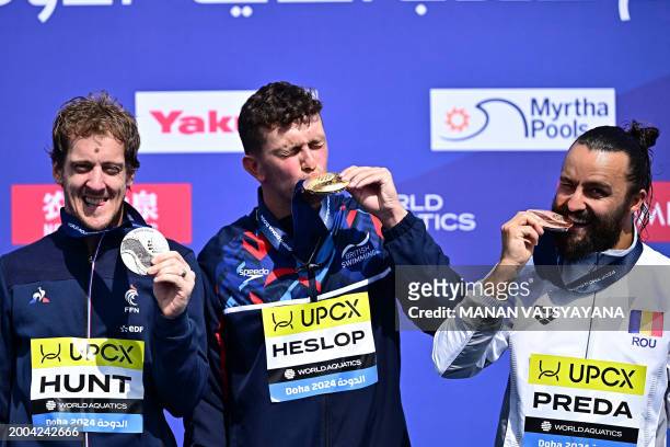 Gold medallist Great Britain's Aidan Heslop , silver medallist France's Gary Hunt and bronze medallist Romania's Catalin-Petru Preda pose during the...