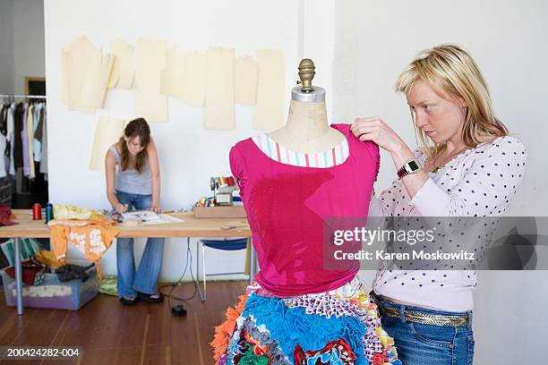 fashion designers working in studio (focus on woman in foreground) - mannequin blonde stockfoto's en -beelden