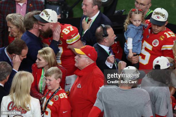 Travis Kelce of the Kansas City Chiefs talks with NFL Commissioner Roger Goodell as Patrick Mahomes holds his daughter after defeating the San...