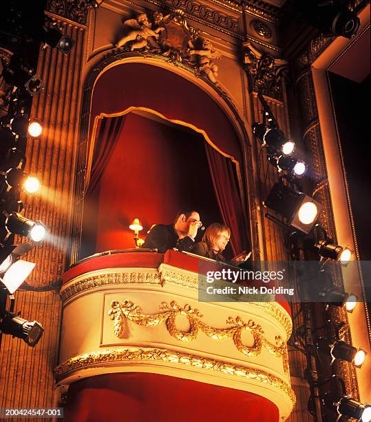 couple sitting in box in theatre, low angle view - loge stock-fotos und bilder