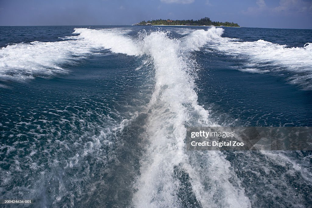 Wake from outboard motorboat on surface of Indian Ocean