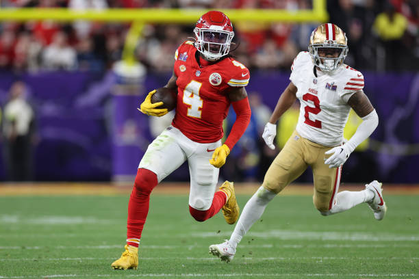 Rashee Rice of the Kansas City Chiefs runs the ball while being chased by Deommodore Lenoir of the San Francisco 49ers in overtime during Super Bowl...