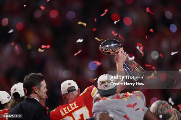 Travis Kelce of the Kansas City Chiefs holds the Lombardi Trophy after defeating the San Francisco 49ers 25-22 during Super Bowl LVIII at Allegiant...