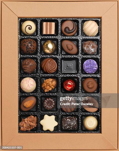 box of chocolates, one missing, overhead view - chocolate box stockfoto's en -beelden