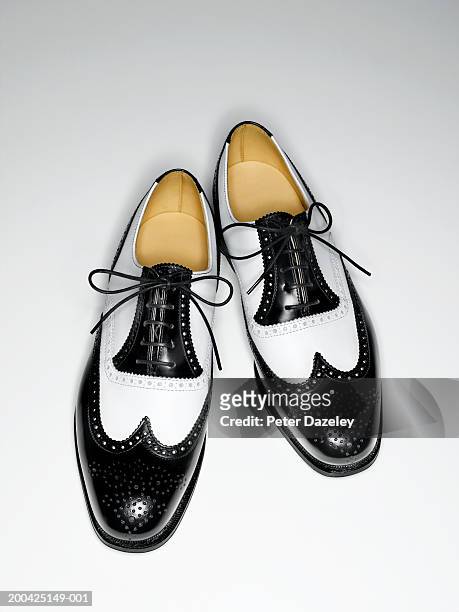 pair of mens black and white classic brogue shoes, elevated view - black shoe 個照片及圖片檔