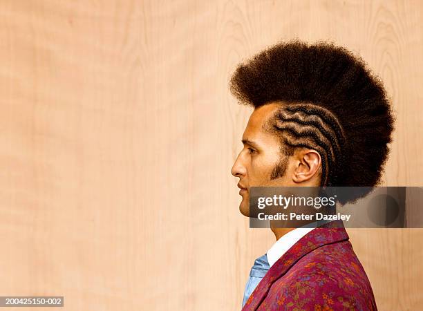 man with mohican style haircut and braiding, profile, close-up - corte de pelo con media cabeza rapada fotografías e imágenes de stock