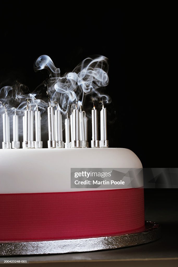 Smoking rising from extinguished candles on cake, close-up