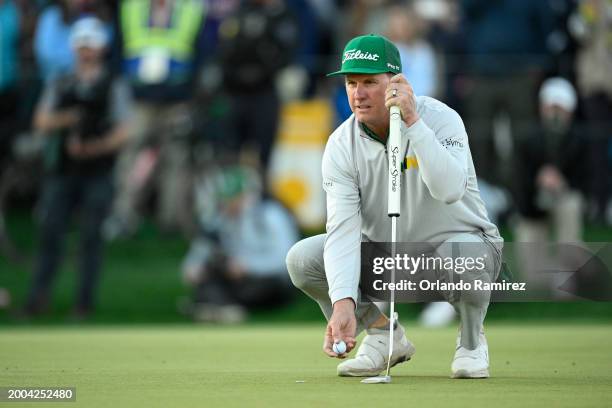 Charley Hoffman of the United States lines up a putt on the second-playoff hole during the final round of the WM Phoenix Open at TPC Scottsdale on...