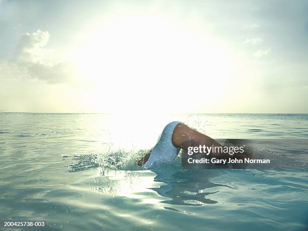 woman diving in ocean, side view - darkwood beach foto e immagini stock