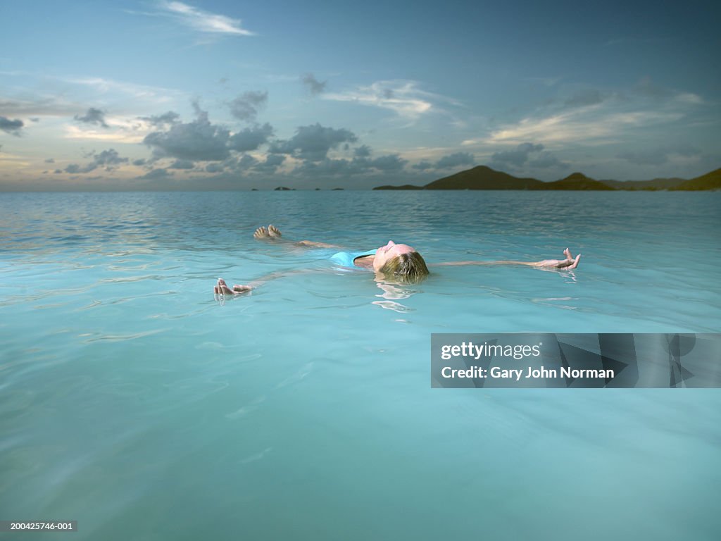 Young woman floating in ocean