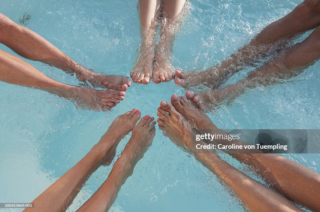 Group of friends in water, low section