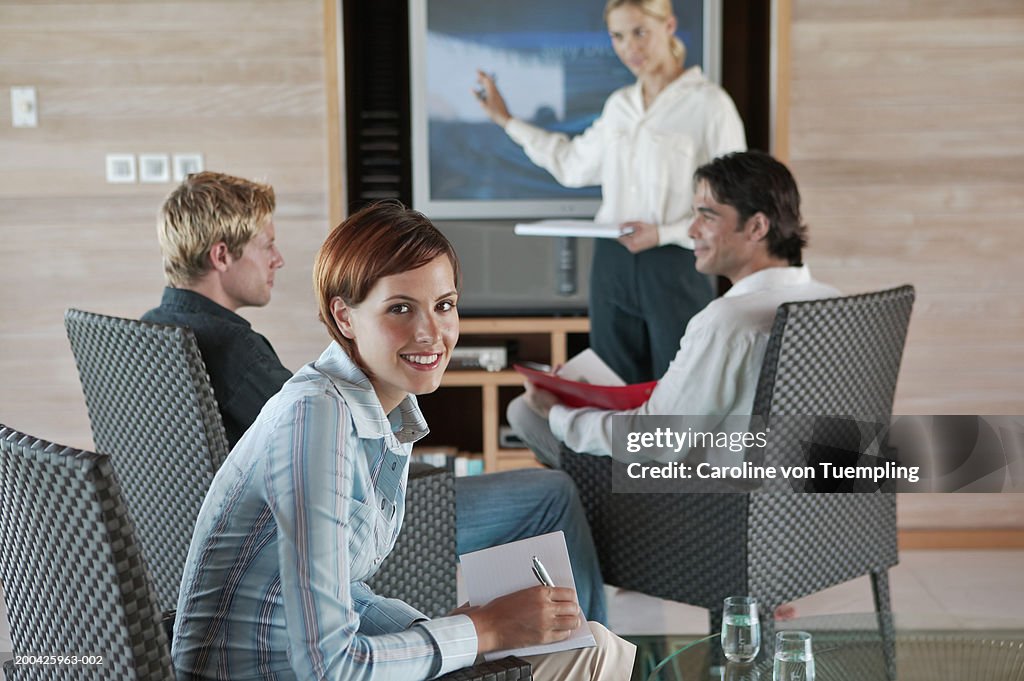 Group of people having meeting, smiling, portrait
