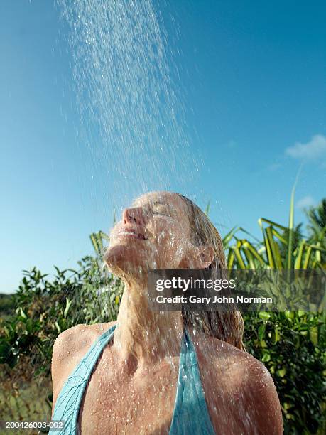 woman showering outdoors - older woman wet hair stock pictures, royalty-free photos & images