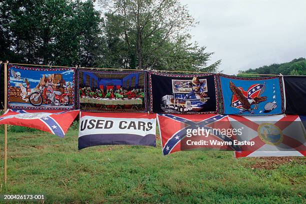 hand painted rugs and flags for sale alongside road - confederate flag stock pictures, royalty-free photos & images