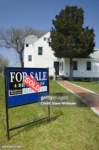 'for sale' sign on lawn in front of house - lawn sign stock pictures, royalty-free photos & images