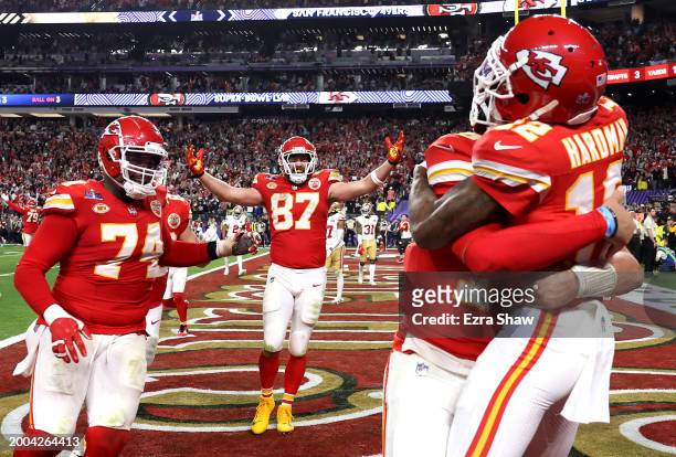 Mecole Hardman Jr. #12 of the Kansas City Chiefs celebrates with Patrick Mahomes and teammates after catching the game-winning touchdown pass to...