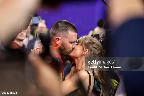 Travis Kelce of the Kansas City Chiefs celebrates and kisses Singer Taylor Swift following the NFL Super Bowl 58 football game between the San...