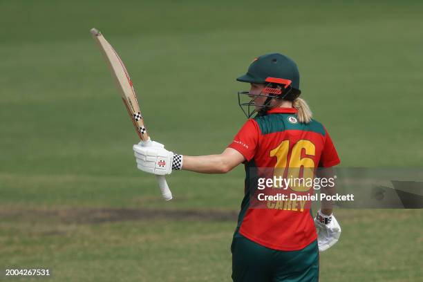 Nicola Carey of Tasmania raises her bat to celebrate making fifty runs during the WNCL match between Victoria and Tasmania at CitiPower Centre, on...