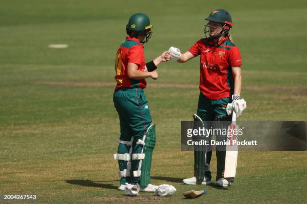 Heather Graham of Tasmania and Nicola Carey of Tasmania bump fists between overs during the WNCL match between Victoria and Tasmania at CitiPower...