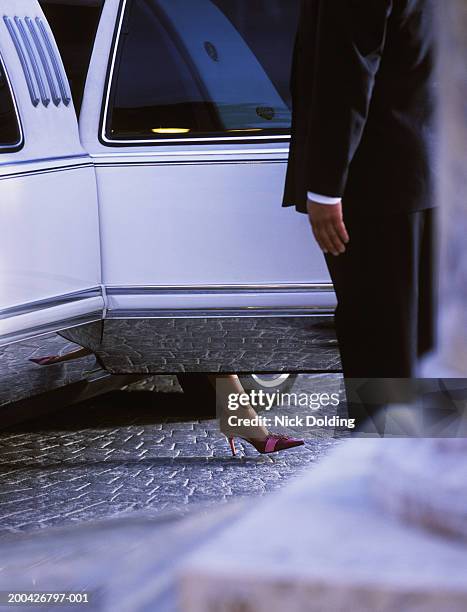 man opening door of limousine for woman, low section - man opening door woman bildbanksfoton och bilder