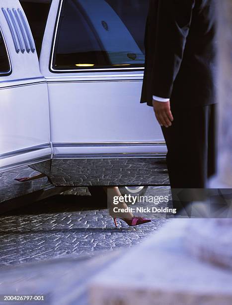 man opening door of limousine for woman, low section - chauffeur 個照片及圖片檔